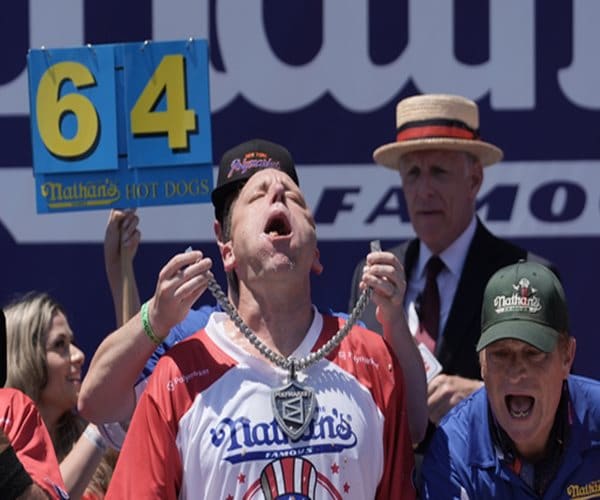 Joey Chestnut Eats 66 Hot Dogs, Claims Mustard Belt at Nathan's Contest: Crowds gathered in the sweltering heat Saturday to celebrate the United States' 250th birthday by watching famed competitive eater Joey "Jaws" Chestnut defend his world hot dog eating championship in Coney Island, where he downed 66 hot dogs in just 10 minutes. #JoeyChestnut #HotDogEating #NathansContest #CompetitiveEating #FoodChallenge 1 56f70438f9c2a52f6503a6baf3afdc18da016e3a