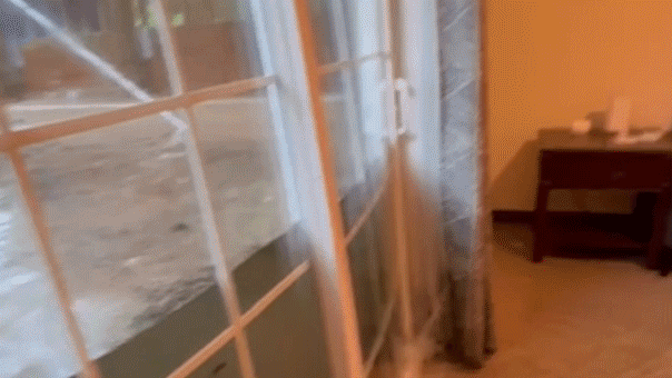 Dramatic video captures floodwaters bursting through glass doors of college students’ home 1 99fafebd36d049db4a2cff382d2b9084207bdd5530bb2004b6f618a3bb58ab0b
